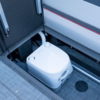 Optional head package including holding tank with a pump out system and a pop-up privacy enclosure