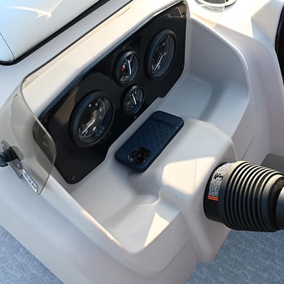 Dashboard featuring four gauges and an open storage area