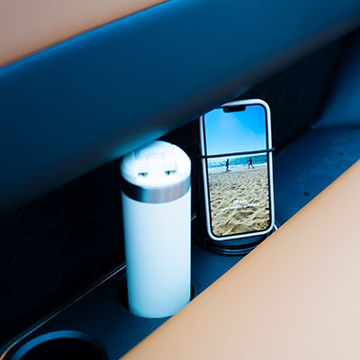 Cup holders with integrated USB-C ports and wireless charger, built into the seating